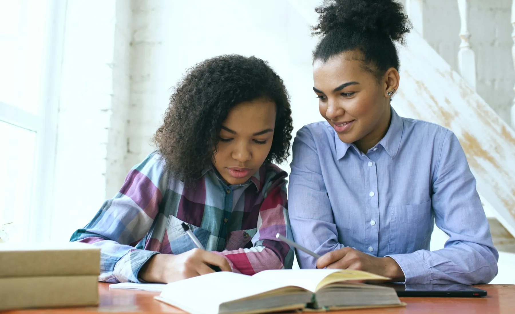 A learner smiling beside a tutor