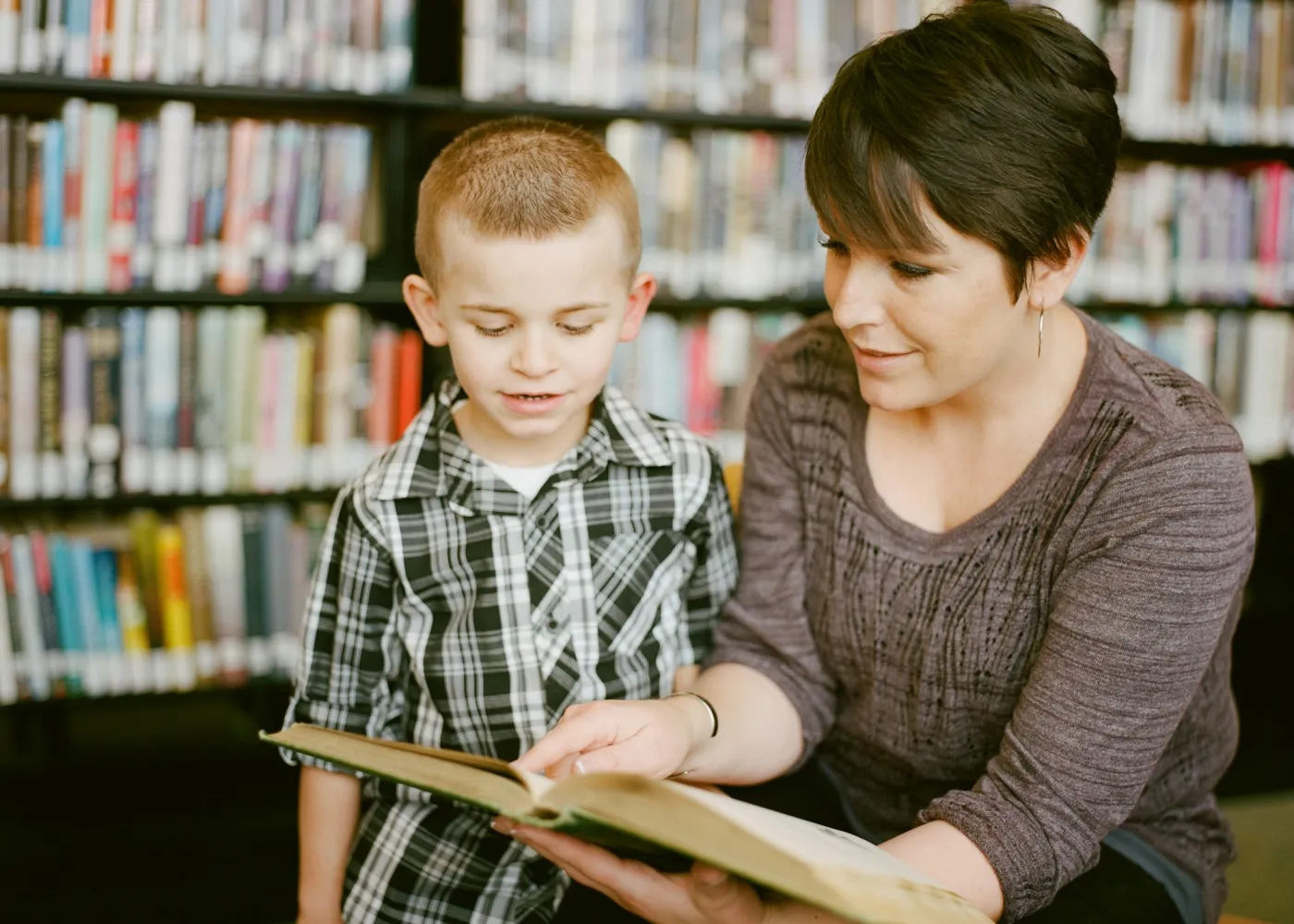 A tutor reading with a child
